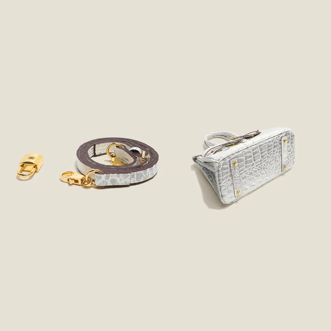 Platinum-Tasche aus Leder mit Kroko-Prägung und goldfarbenem Drehverschluss