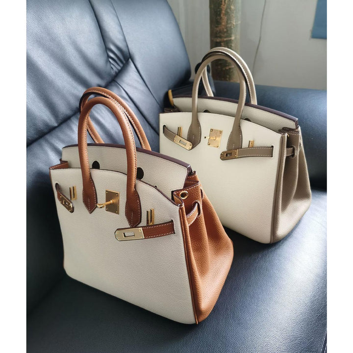 Birk-Handtasche aus Togo-Narbenleder mit Drehverschluss und Rollhenkeln