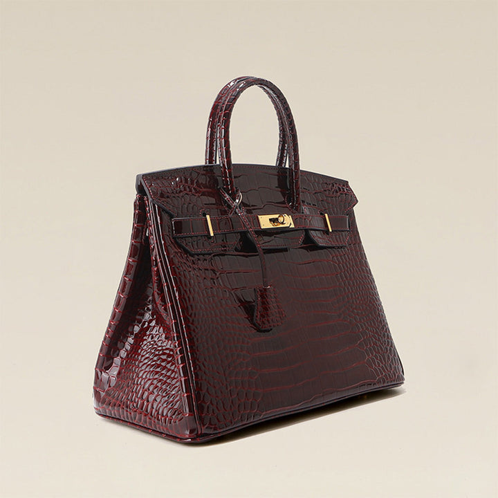 Birk-Handtasche aus Leder mit Kroko-Prägung in Rouge mit goldenem Drehverschluss