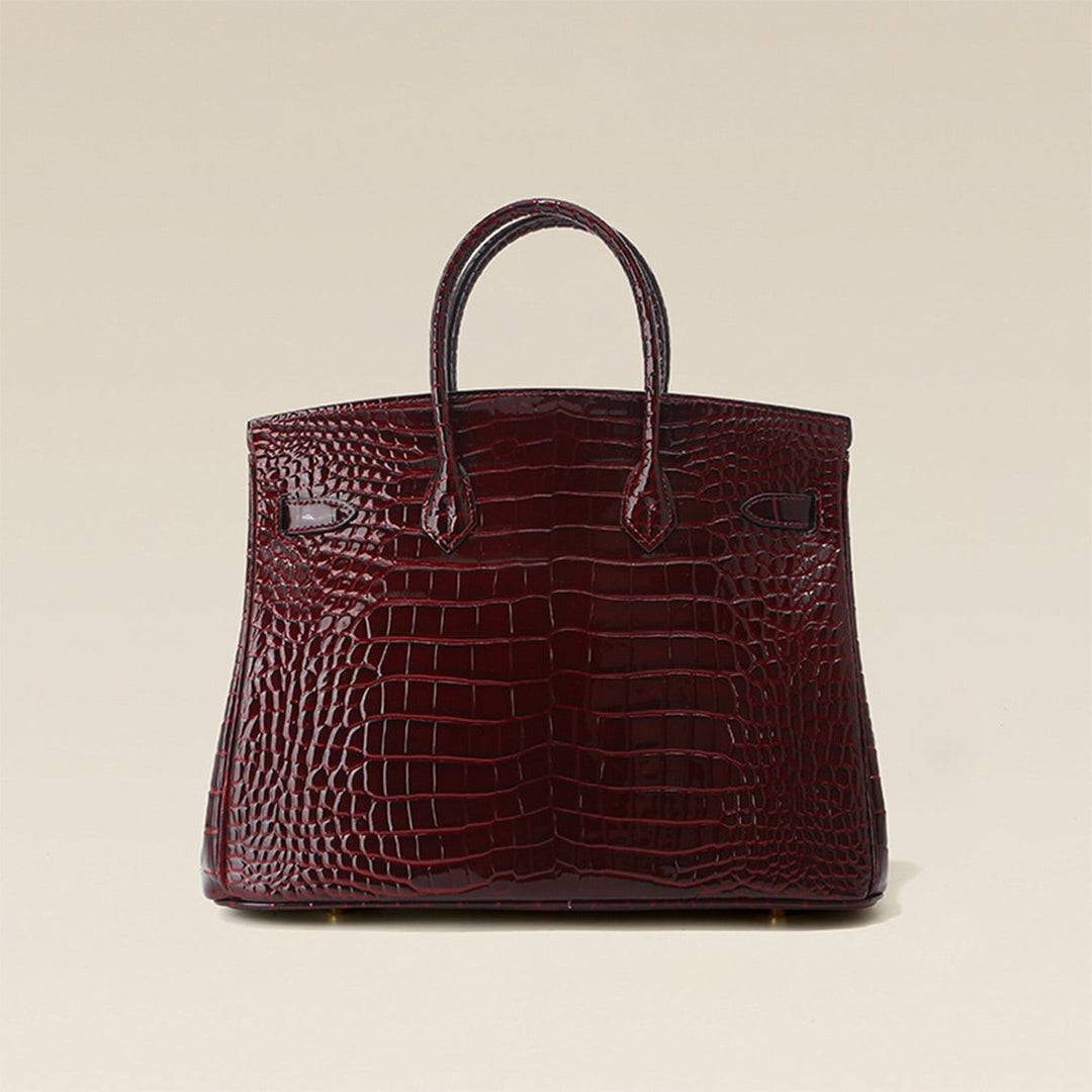 Birk-Handtasche aus Leder mit Kroko-Prägung in Rouge mit goldenem Drehverschluss