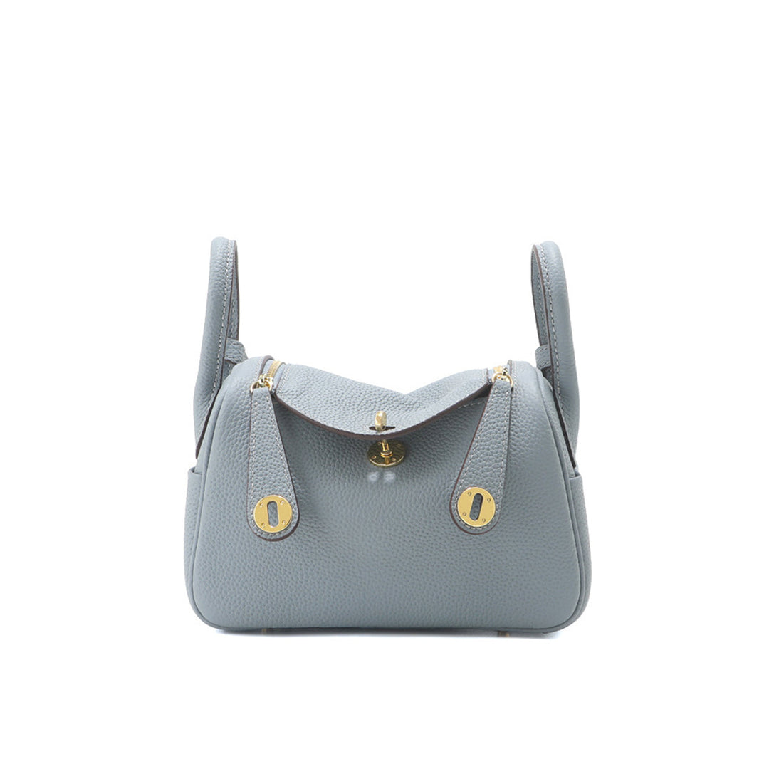 Lindi Tasche aus Narbenleder mit Henkeln und goldenen Beschlägen