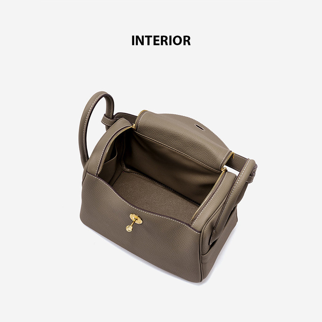 Lindi Tasche aus Narbenleder mit Henkeln und goldenen Beschlägen