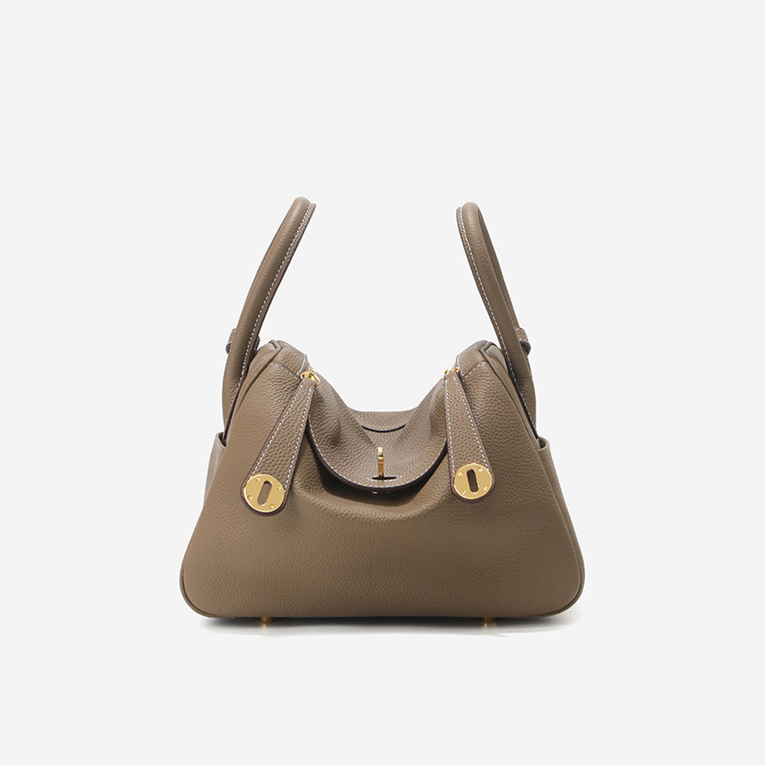 Lindi Tasche aus Narbenleder mit Henkeln und goldenen Beschlägen